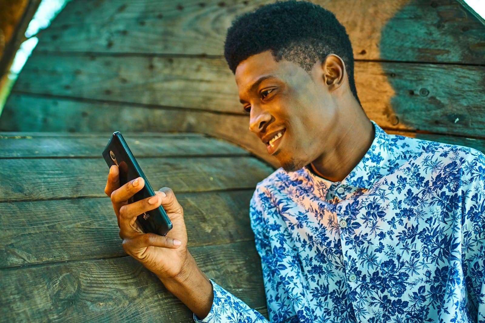 Smiling man using a mobile app on his phone