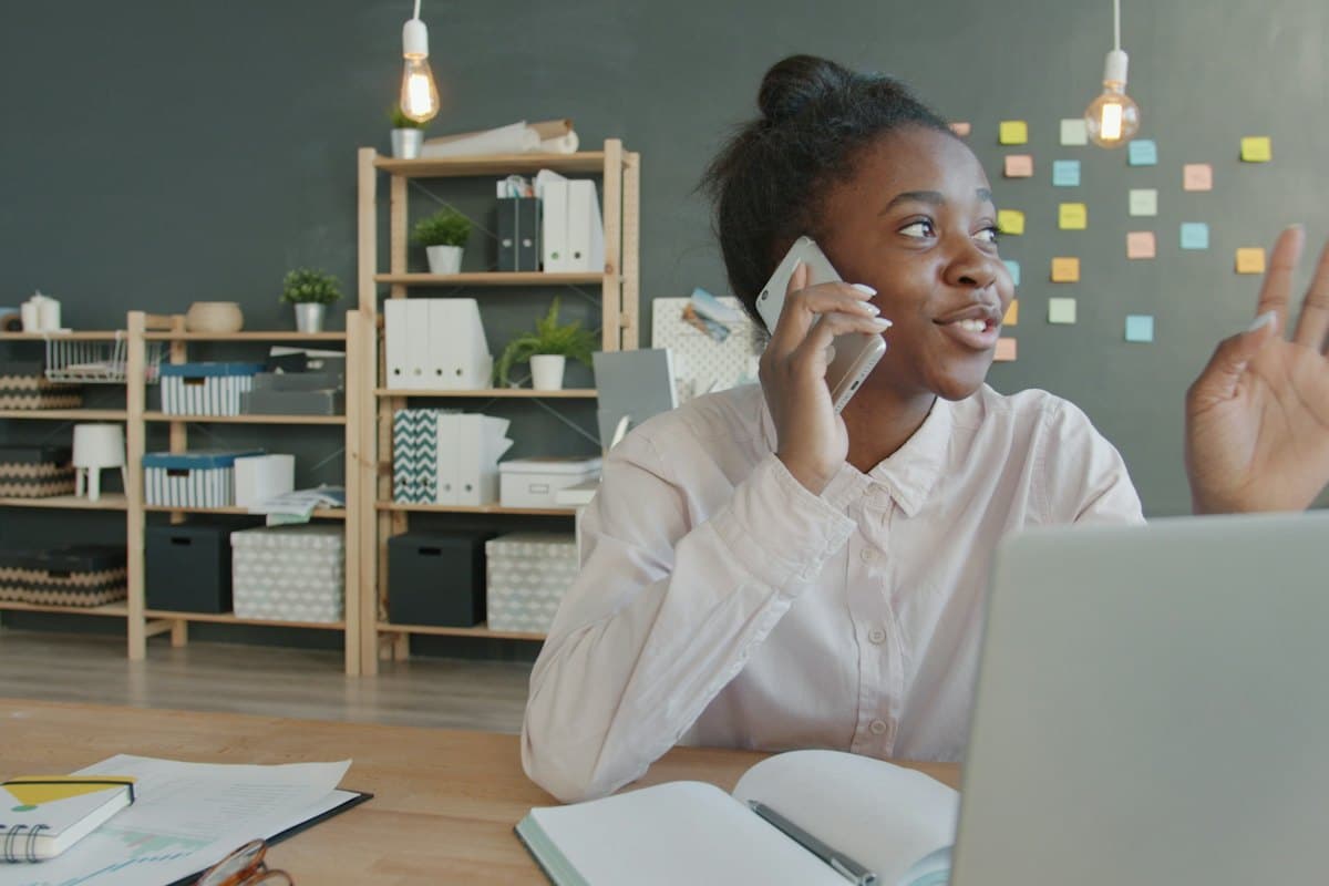 A woman on a call at her desk