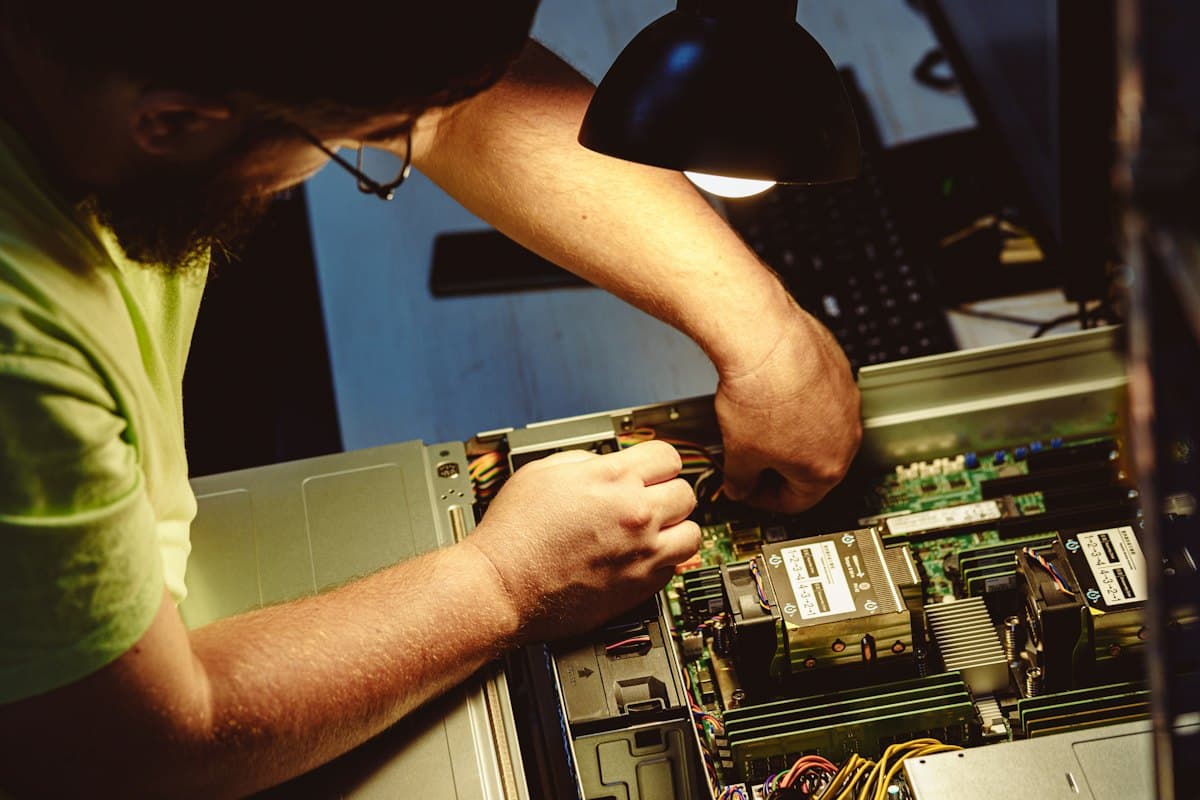 A technician fitting components inside a computer
