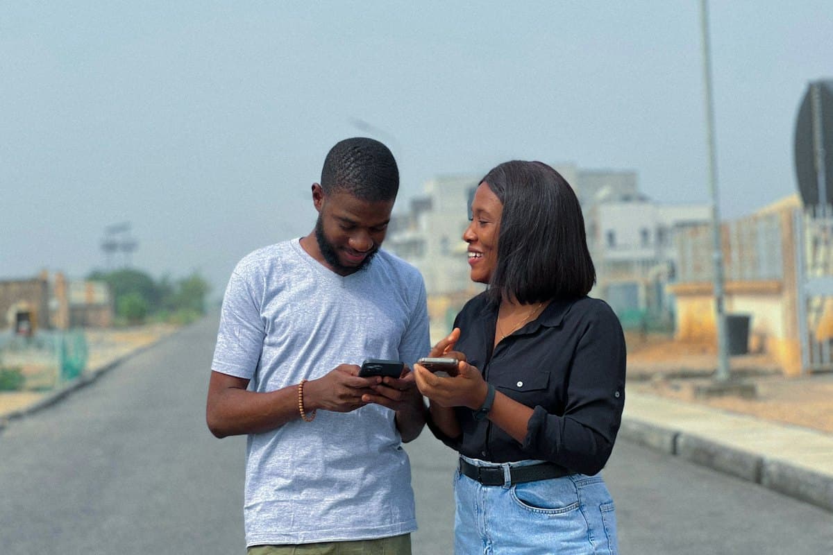 Two colleagues comparing an app on their phones