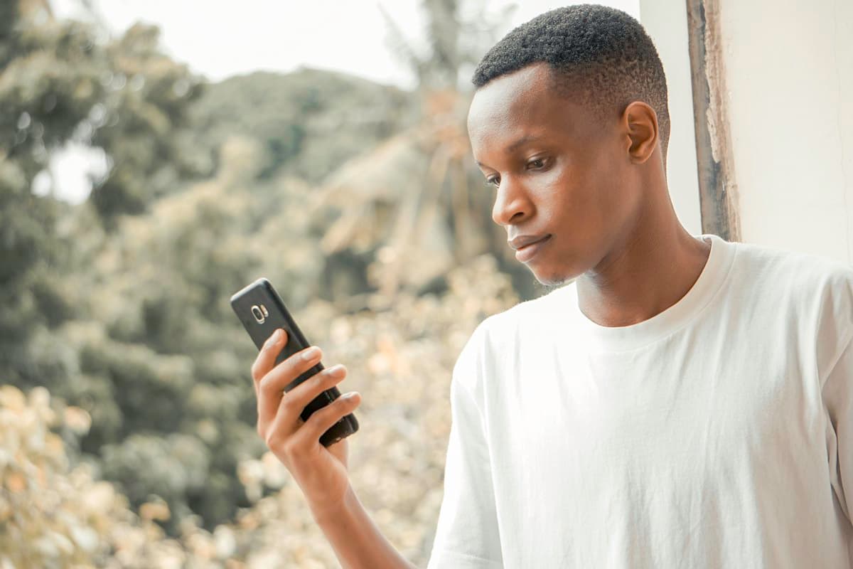 A young man reading on his smartphone