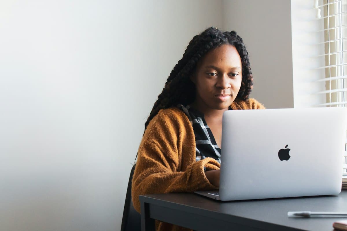 A woman reviewing a site on her laptop